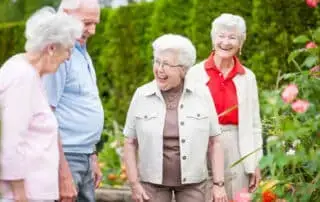 seniors outside walking by the garden